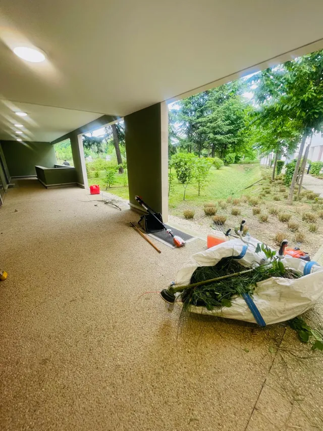 Déchets verts rassemblés dans un sac sous le passage couvert d'une résidence