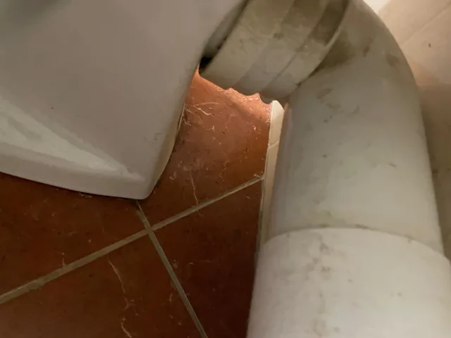 Pipe d'évacuation d'un WC et son raccord au tuyau